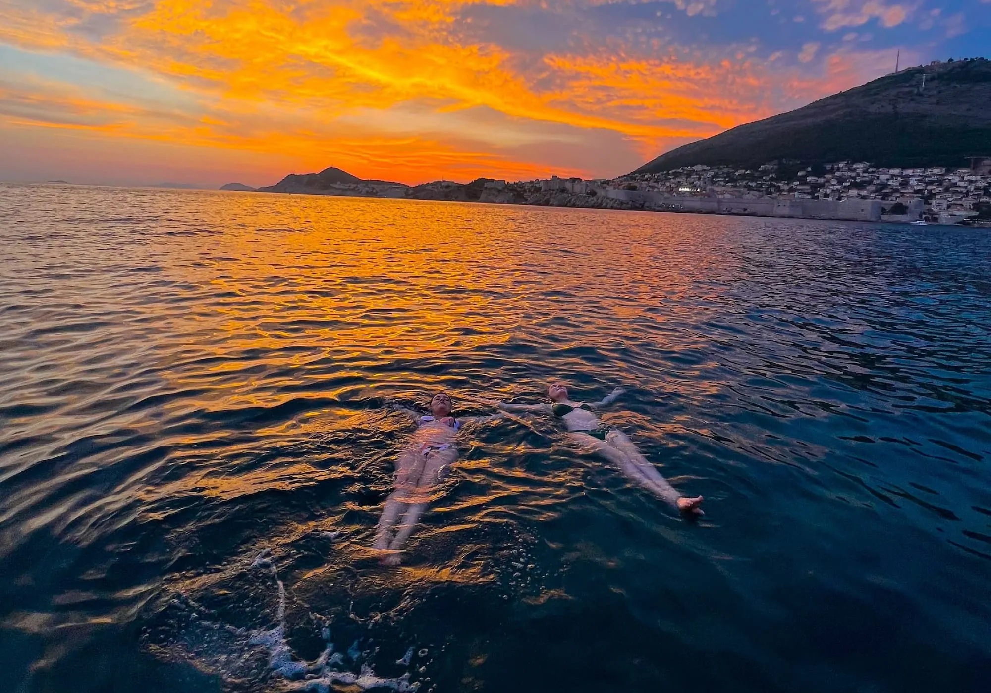 Dubrovnik sunset cruise private boat tour - city walls from the sea at golden hour